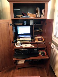 cluttery desk in a corner